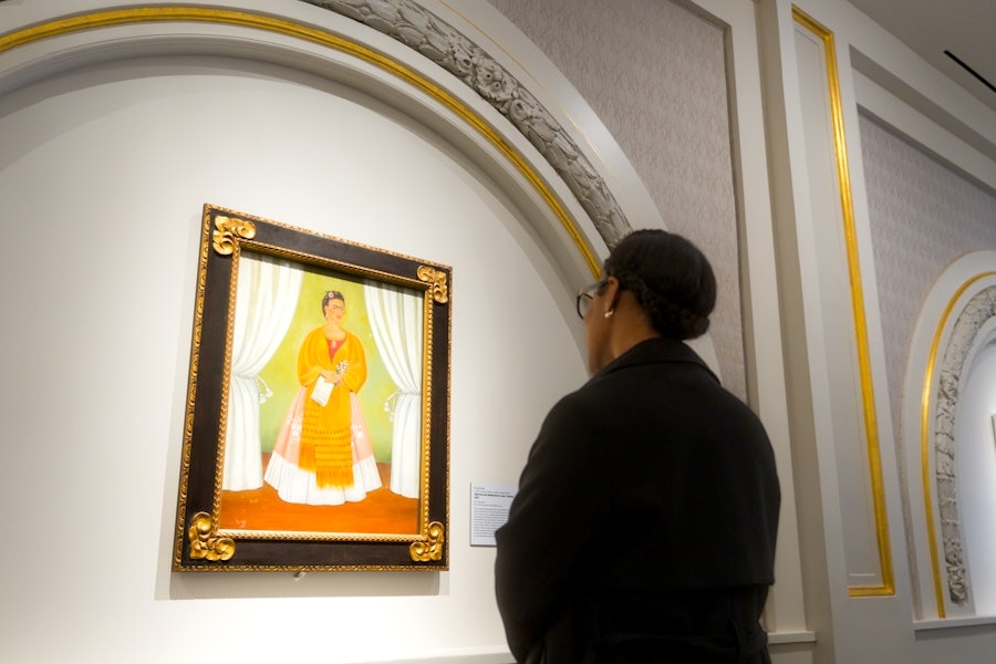 A woman gazes at a self portrait of Frida Kahlo at the National Museum of Women in the Arts.