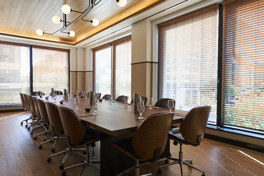Room full of light and wood that is set for a small meeting