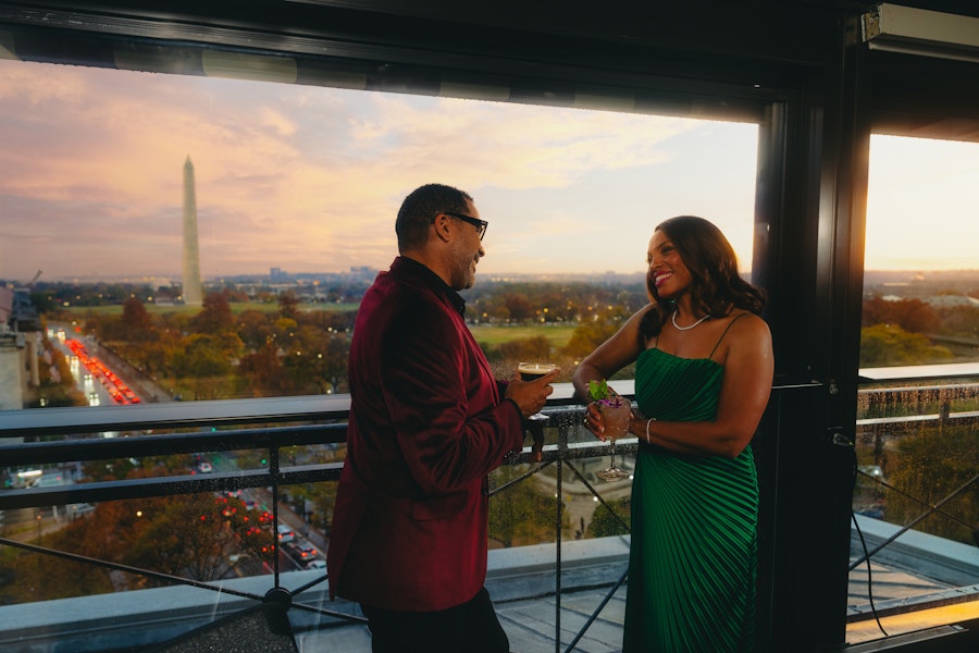 VUE with a couple with drinks in their hand for happy hour