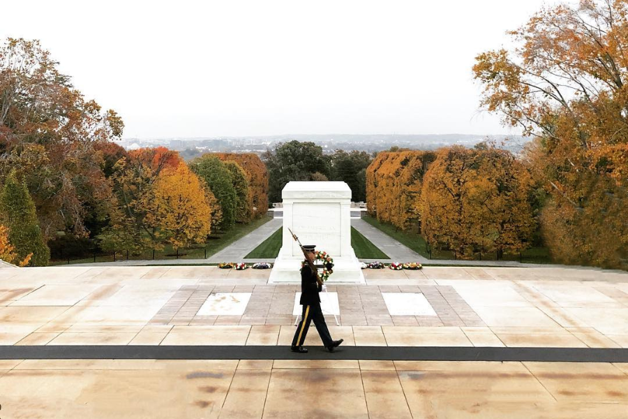 A guard walks solemnly in front of the Tomb of the Unknown Soldier at Arlington National Cemetery.