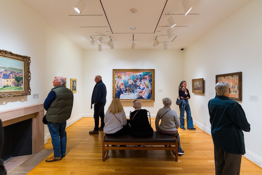 Visitors admire Renoir’s “Luncheon of the Boating Party” at The Phillips Collection in Washington, DC.