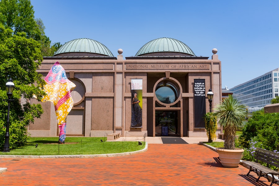 The entrance to the National Museum of African Art features domed roofs, banners and a brick walkway.