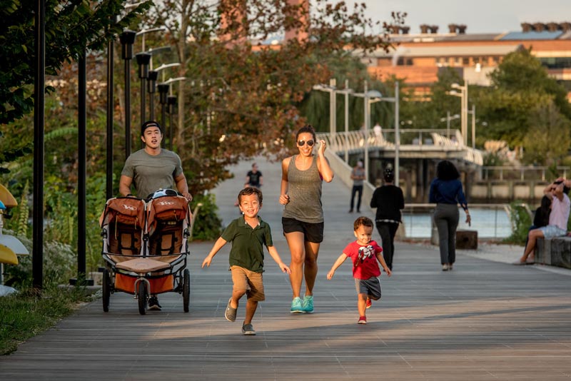 Family running along Anacostia Riverwalk Trail - Outdoor exercise and trails in Washington, DC