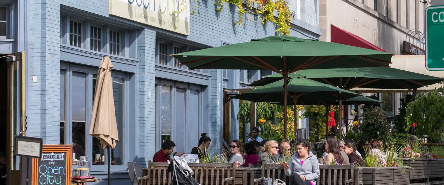 People enjoy outdoor seating at Open City in Washington, DC on a sunny day.